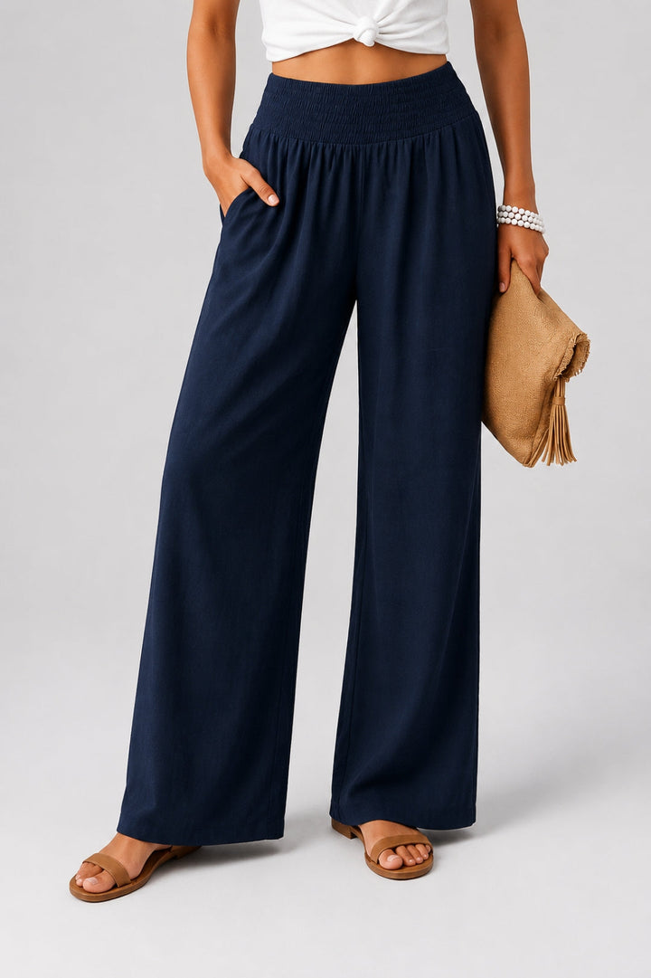 Women's linen pants with a wide leg, high smocked waistband, and pockets