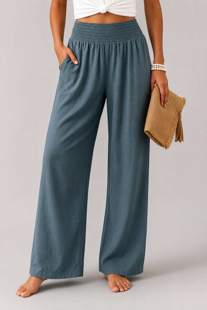 Women's linen pants with a wide leg, high smocked waistband, and pockets