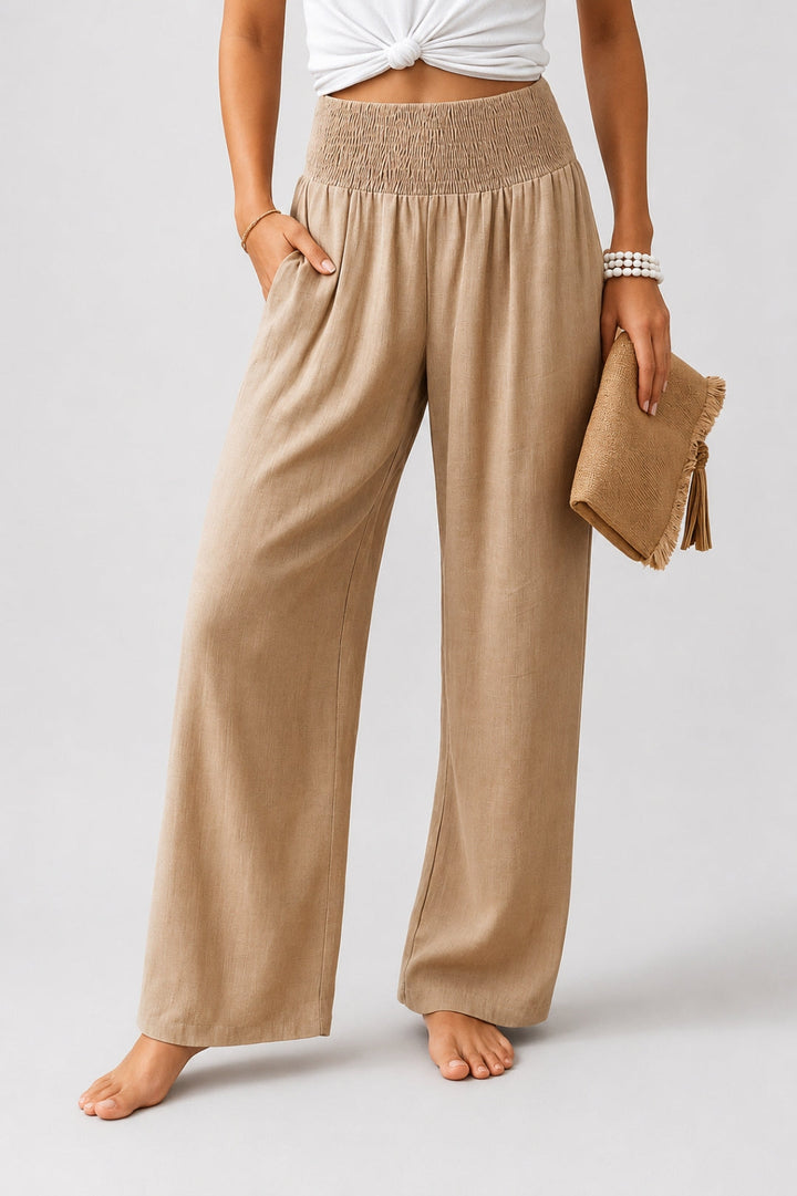 Women's linen pants with a wide leg, high smocked waistband, and pockets